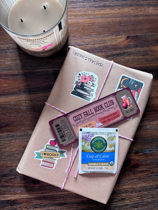 Gift box with book-themed stickers on a wooden surface